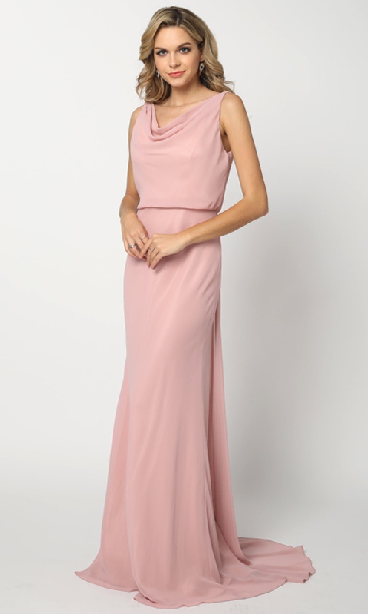 A woman poses in the Juliet 670 long prom dress, featuring a sleeveless design, floor-length blush pink skirt, and elegant cowl neckline against a plain white background.